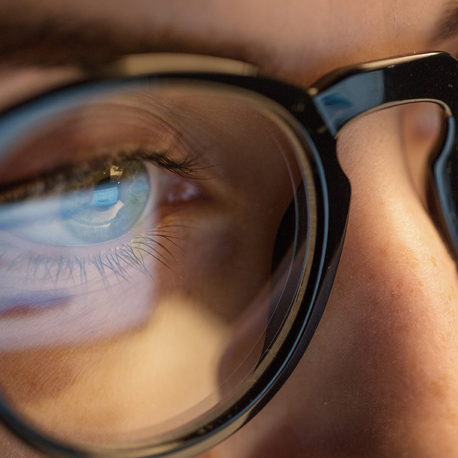 Reflection in glasses as client looks at EMDR bilateral stimulation on a computer screen